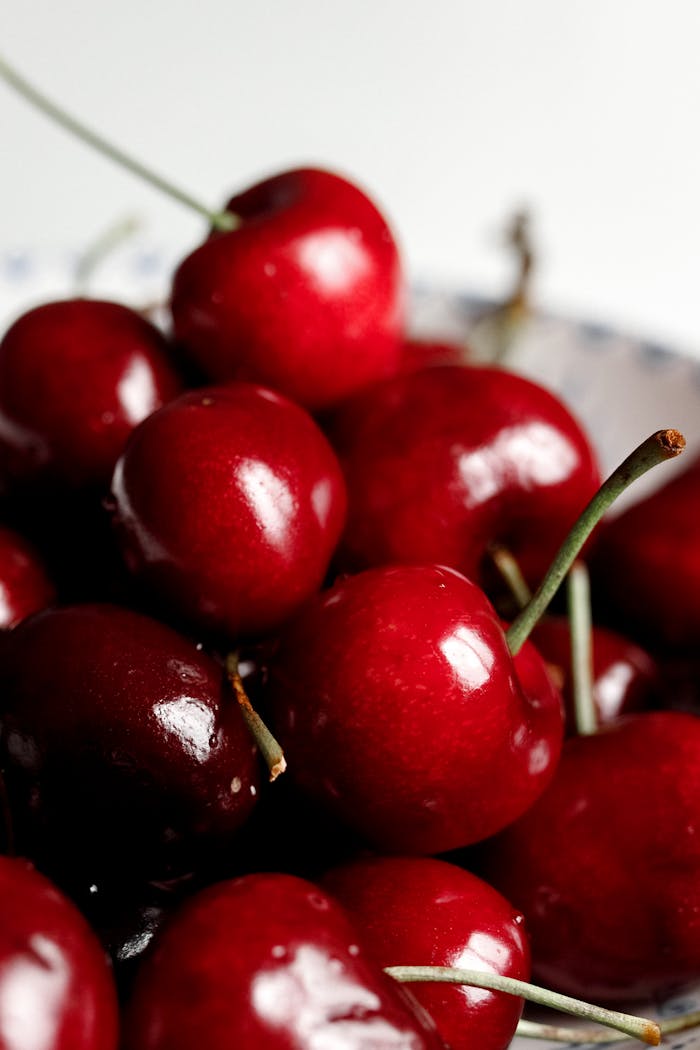 creative-approach-img A vibrant close-up of fresh, ripe red cherries with glossy surfaces.